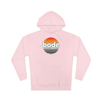 The 2026 Bode Summer Bootcamp — Cali Sunset Hoodie Sweatshirt (SS4500) by Printify is a light pink cotton-poly fleece hoodie with a front pocket, adjustable hood, and "bode SUMMER CAMP" logo featuring an orange-yellow sunset above green text.