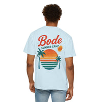 Man wearing a light blue Printify BODE Summer Camp T-Shirt 2026 — "Throwback Sunset" (Unisex Comfort Colors 1717), featuring a sunset and palm trees graphic with "Bode Summer Camp 2024" on the back.