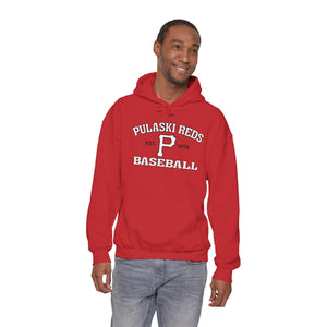 A man in jeans and a red Printify "P Reds Baseball Est. 1978 - Unisex Heavy Blend™ Hooded Sweatshirt Volume" smiles against a plain white background.