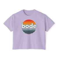 The Printify 2026 Bode Summer Bootcamp Cali Sunset Logo Crop T-Shirt (3023CL) is a lavender, ultra-soft ring-spun cotton tee with a boxy cropped fit and "bode SUMMER CAMP" over a retro sunset graphic.