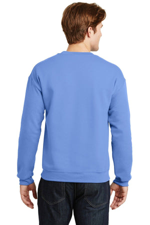 A person dressed in a light blue Gildan Heavy Blend Crewneck Sweatshirt 18000 and dark jeans, shown from the back.