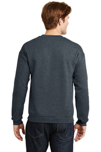 A person wearing a dark gray Gildan Heavy Blend Crewneck Sweatshirt 18000 and jeans stands with their back to the camera, highlighting the comfortable 50/50 cotton-poly blend design.