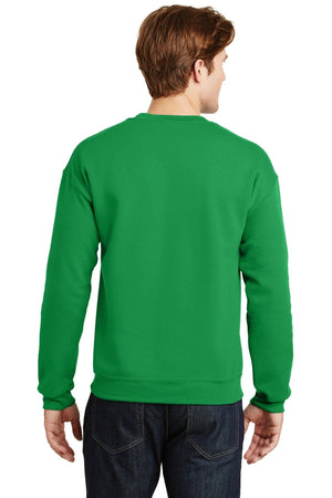 A person is seen from behind wearing a green Gildan Heavy Blend Crewneck Sweatshirt 18000, crafted with a comfortable 50/50 cotton-polyester blend, paired with dark jeans.