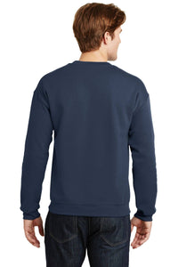 A person wearing a Gildan Heavy Blend Crewneck Sweatshirt 18000 in navy blue and dark jeans stands facing away from the camera.