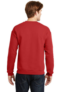 A person wearing a plain red Gildan Heavy Blend Crewneck Sweatshirt 18000 and dark jeans is facing away from the camera.