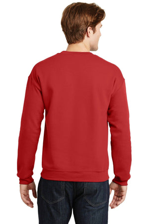 A person wearing a plain red Gildan Heavy Blend Crewneck Sweatshirt 18000 and dark jeans is facing away from the camera.