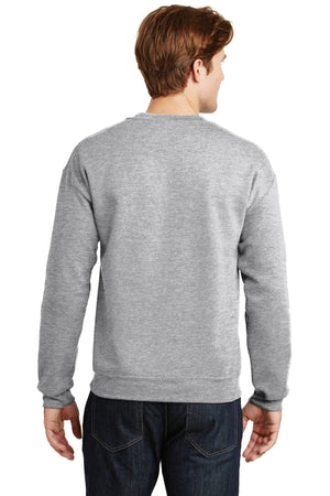 A person wearing a gray Gildan Heavy Blend Crewneck Sweatshirt 18000 and dark jeans is standing with their back to the viewer.