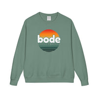 The Printify 2026 Bode Summer Bootcamp Crewneck Sweatshirt (GDH400) is a green Hanes Comfortwash fleece with a vintage wash and DTF-printed sunset graphic and "bode SUMMER CAMP" text on the front.