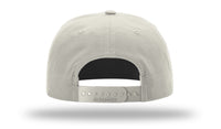 Back view of a gray Richardson 256 Umpqua Rope Snapback Cap with an adjustable strap featuring multiple snap holes, UPF 50+ protection, and the brand name "Richardson" imprinted on it.