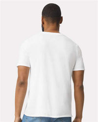 A man with his back to the camera wears a plain white Gildan 64000 Softstyle® T-shirt (pack of 36, custom screen printed logo included) and blue jeans against a light background.