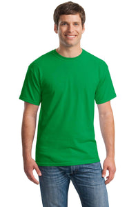 A man in a Gildan Heavy 100% Cotton Custom T-Shirt (Gildan 5000) and blue jeans stands facing forward, smiling at the camera against a white background.