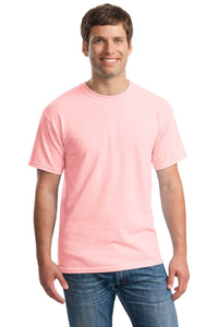 A man smiles, wearing a Gildan Heavy 100% Cotton Custom T-Shirt (Gildan 5000) in light pink and blue jeans, standing against a white background.