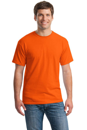 A man smiles against a plain white background wearing the Gildan Heavy 100% Cotton Custom T-Shirt (Gildan 5000) in bright orange and blue jeans.