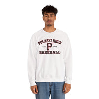 A person wears the Printify P Reds Baseball Est. 1978 - Unisex Heavy Blend™ Crewneck Sweatshirt with "Pulaski Reds Baseball Est. 1978" on the front, styled with blue jeans and standing against a white background.