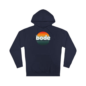 The 2026 Bode Summer Bootcamp — Cali Sunset Hoodie Sweatshirt - SS4500 by Printify is a navy blue hoodie with "bode SUMMER CAMP" text and a retro sunset graphic on the chest, made from soft cotton-poly fleece.