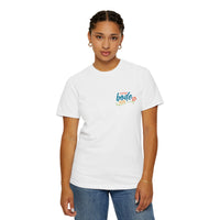 A woman stands facing forward against a white background, wearing Printify’s heavyweight cotton Summer Camp T-Shirt featuring the 'Life Is Better Together' beach can design and durable double-needle stitching, paired with blue jeans.