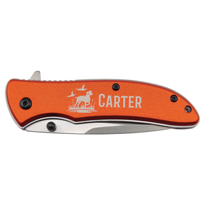 The Bison River 4 1/4" Everyday Carry Knife features a custom laser-engraved orange handle with a dog, birds, and "Carter," making it ideal for corporate gifts or promotional giveaways.