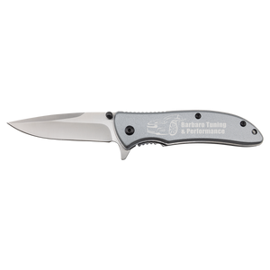 The Bison River 4 1/4" Everyday Carry Knife by Bison River features a silver handle custom laser engraved with "Barbaro Tuning & Performance" and a car outline, plus a partially serrated blade—ideal for promotions or corporate gifts.