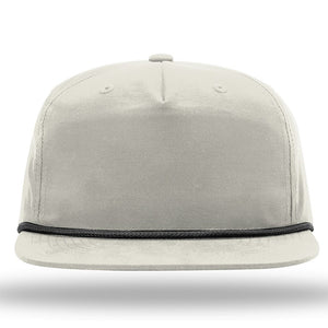 Front view of a light gray Richardson 256 Umpqua Rope Snapback Cap with black cord detail above the brim, featuring UPF 50+ protection, set against a white background.