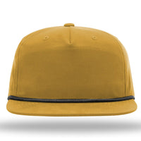 A Richardson 256 Umpqua Rope Snapback Cap in mustard yellow, featuring a flat brim and black trim around the base, stands out in the image and offers UPF 50+ sun protection.
