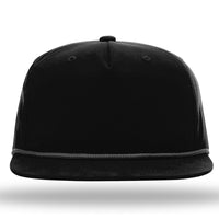 A black Richardson 256 Umpqua Rope Snapback Cap with a flat brim and a decorative cord above the brim, shown from the front on a white background.