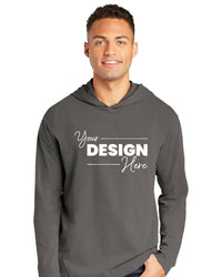 A person wearing a gray Comfort Colors Ring Spun Long Sleeve Hoodie Shirt 4900 with "Your Design Here" printed in white on the front.