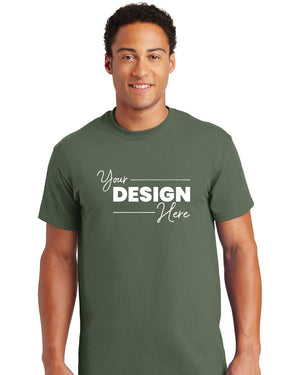 A man wearing a Gildan - 100% US Cotton T-Shirt 2000 in green, featuring the text "Your Design Here" printed on the front.