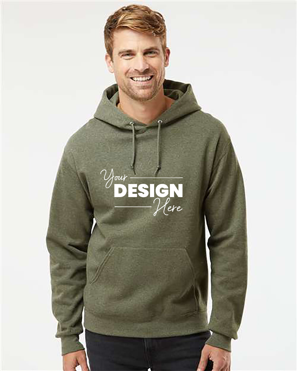 A person is wearing a green JERZEES Jerzees NuBlend Hoodie Sweatshirt with the text "Your Design Here" on the front. They are smiling and standing against a plain background, showcasing the high-quality, pill-resistant fleece that's perfect for bulk customized orders.
