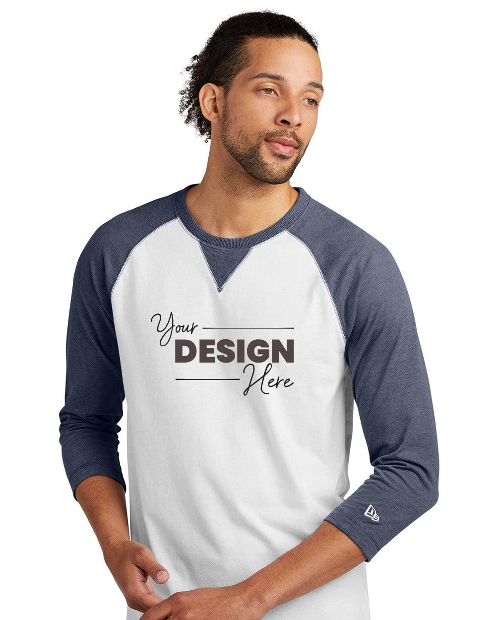 A man in a white and blue New Era Cotton Blend 3/4-Sleeve Baseball Raglan T-Shirt (NEA121) with "Your Design Here" stands against a plain white background, highlighting the ideal canvas for your custom New Era style.