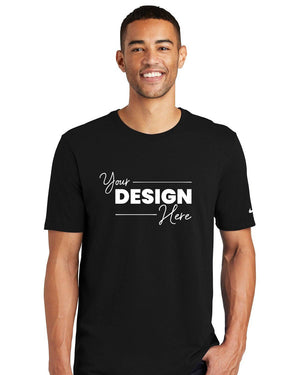 A person is wearing the Nike Core Cotton T-Shirt NKBQ5233 in black, made from pure cotton and featuring the text "Your Design Here," making it ideal for anyone interested in creating their own customized t-shirts.