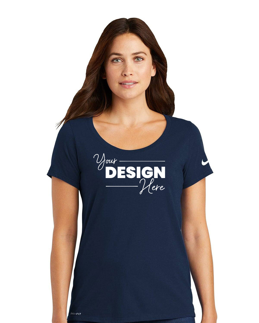 A woman wears a navy Nike Ladies Dri-FIT Cotton/Poly Scoop Neck T-Shirt (NKBQ5234) with "Your Design Here" printed on the front.