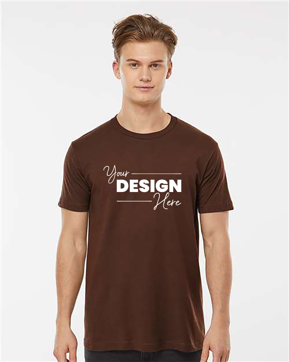 A young man wearing a Tultex Unisex Fine Jersey T-Shirt made of soft 100% ringspun cotton, featuring the text "Your Design Here" printed on the front, stands against a plain white background.