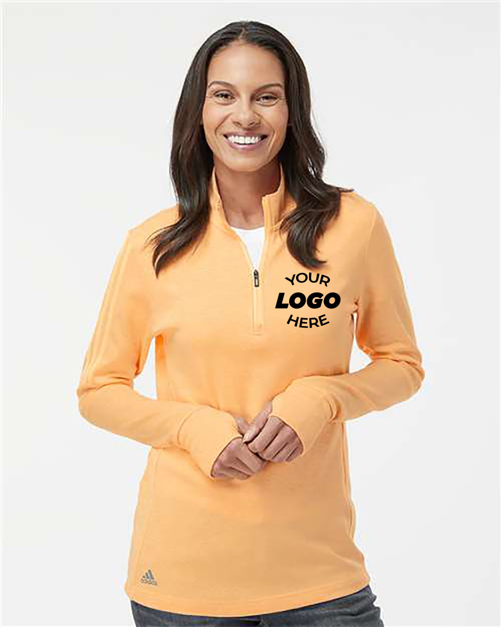 A woman wearing an orange Adidas Women's 3-Stripes Quarter-Zip Sweater, featuring "Your Logo Here" on the front and boasting moisture management properties.