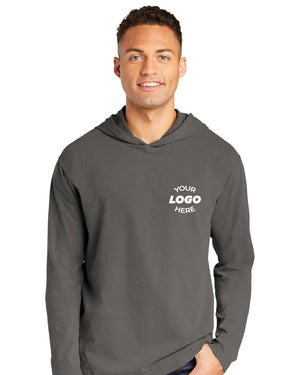 A man wears a Comfort Colors Ring Spun Long Sleeve Hoodie Shirt 4900 in gray with "YOUR LOGO HERE" printed on the left chest.