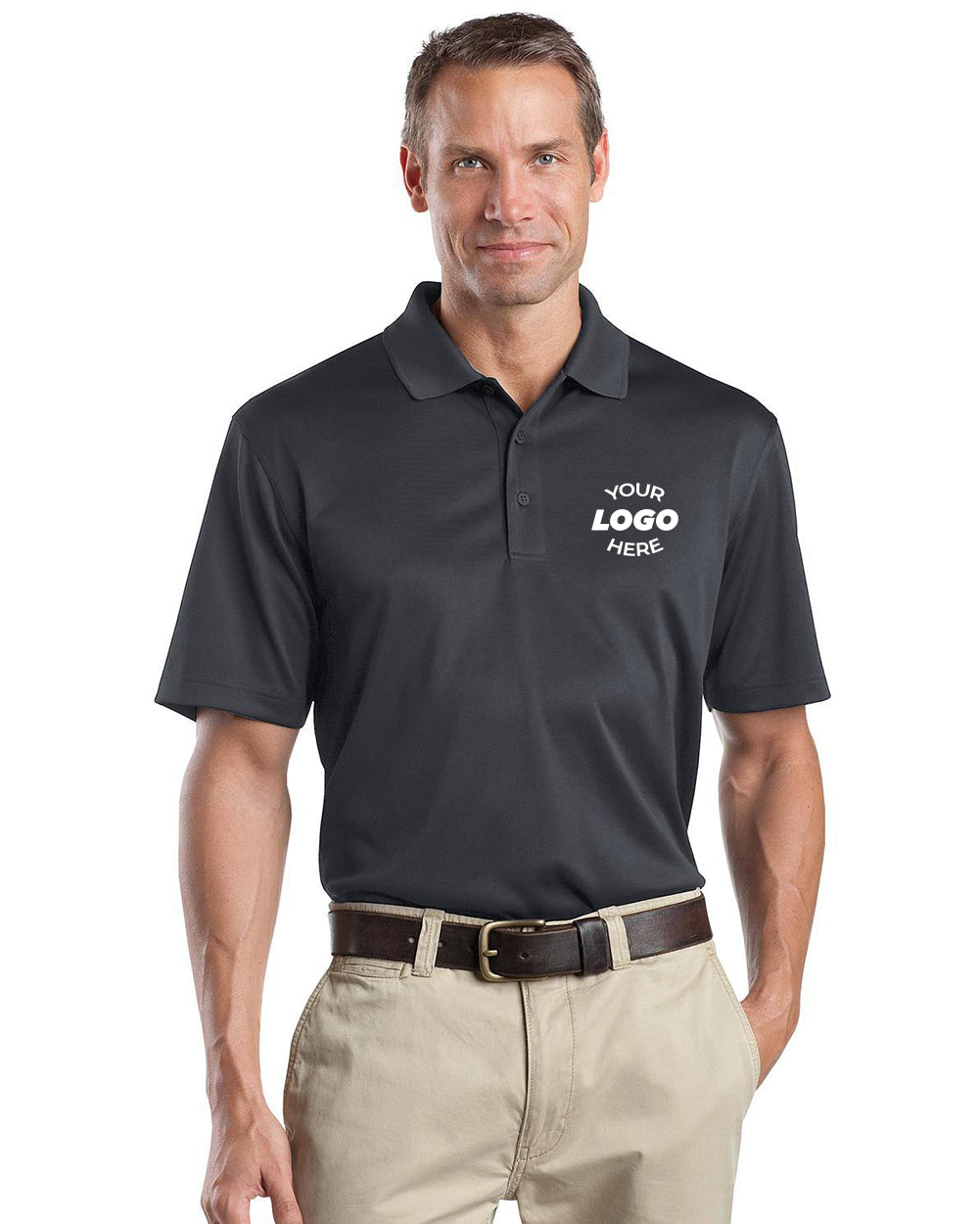 A man wears the CornerStone Select Snag-Proof Polo CS412 in black with "Your Logo Here" on the left chest, paired with khaki pants and a brown belt, standing against a white background for a professional look.