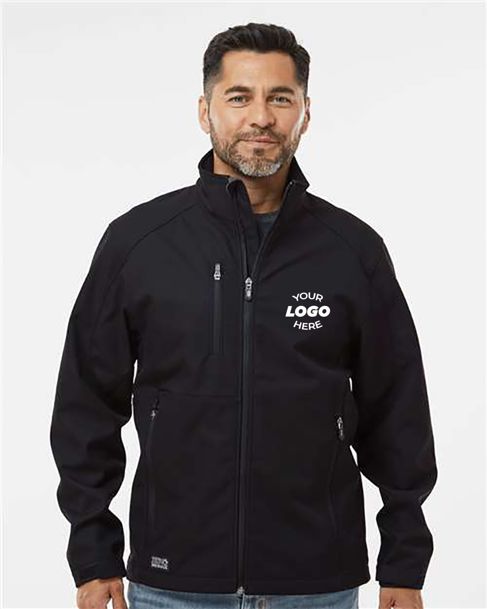 A man with short dark hair and a beard is wearing the DRI DUCK Midweight Acceleration Jacket, which features "YOUR LOGO HERE" on the left chest. Made from durable workwear material with Teflon™ Shield+ fabric protector, his jacket stands against a plain white background.