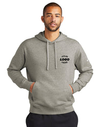 A man wearing a gray Nike Club Fleece Sleeve Swoosh Pullover Hoodie Sweatshirt NKDR1499, with "Your Logo Here" printed on it, has his hands in the front pocket, showcasing a casual, street-ready look against a white background.