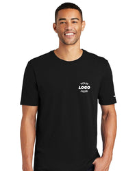 A person is wearing a Nike Core Cotton T-Shirt NKBQ5233, made from pure cotton, featuring the text "Your Logo Here" on the chest.