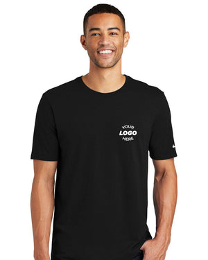 A person is wearing a Nike Core Cotton T-Shirt NKBQ5233, made from pure cotton, featuring the text "Your Logo Here" on the chest.