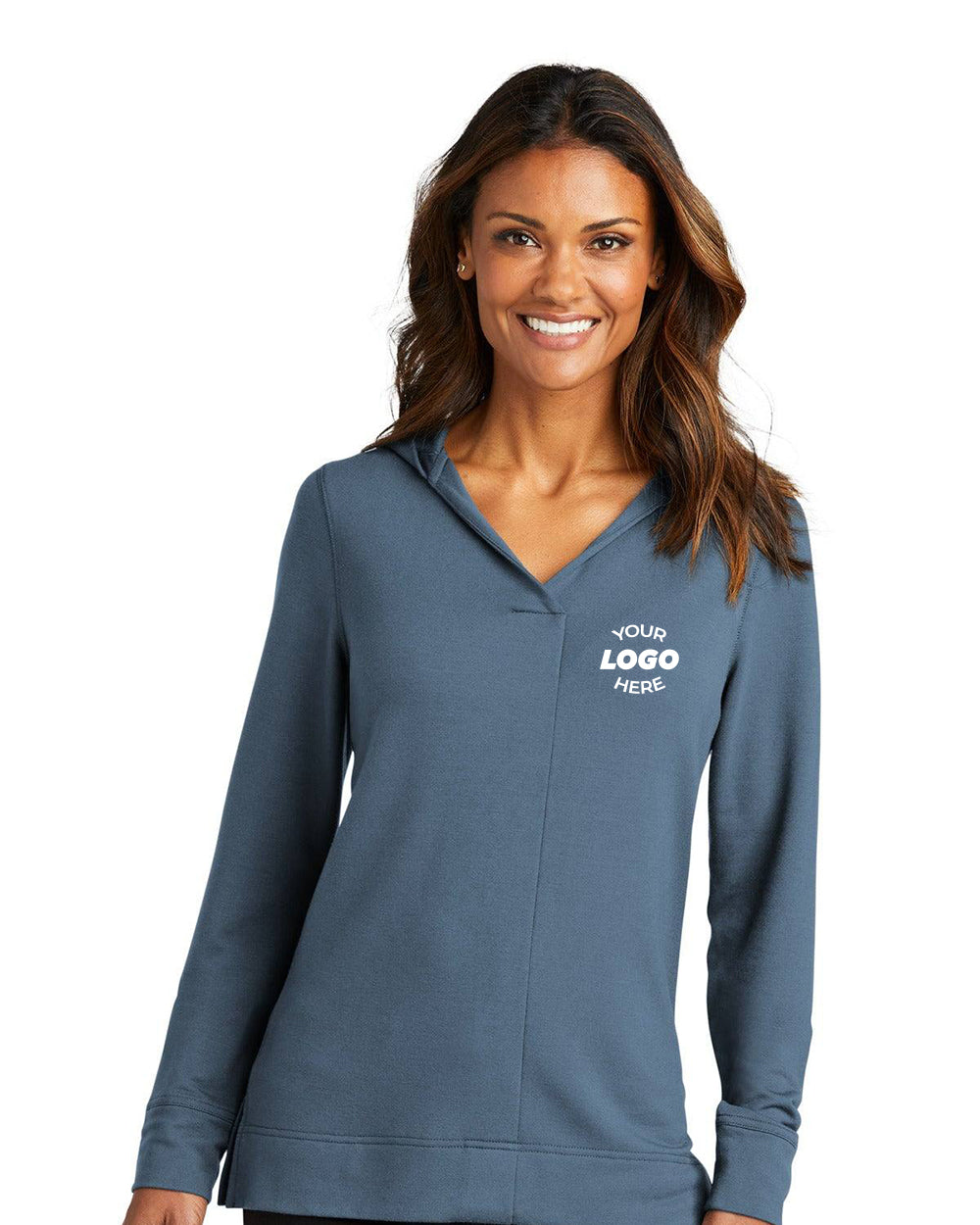 A woman wearing a Port Authority Ladies Microterry Pullover Hoodie LK826 with "YOUR LOGO HERE" printed on the left chest stands and smiles at the camera.