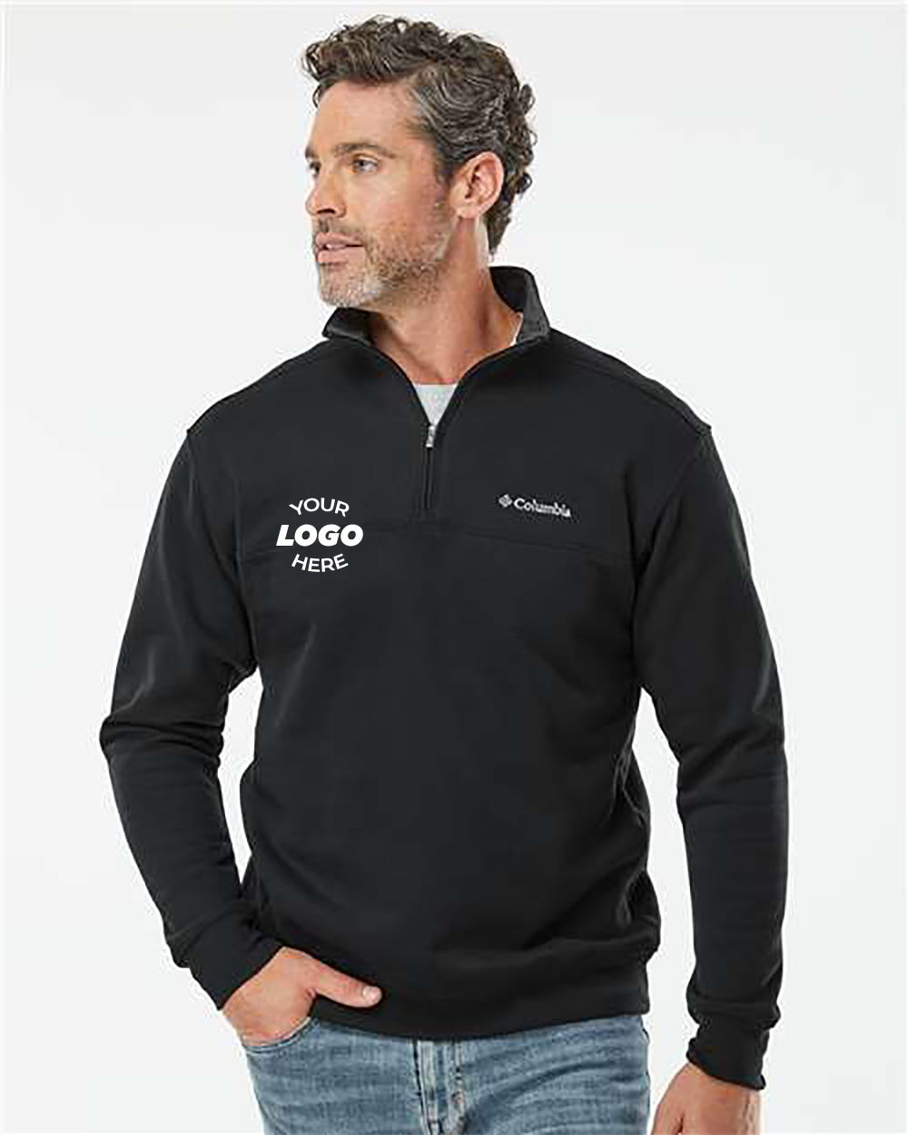 A man wearing a Columbia Hart Mountain Half-Zip Sweatshirt in black with "Your Logo Here" printed on the left chest. He is looking to the left against a plain background. Perfect for outdoor activities or as comfortable workwear.