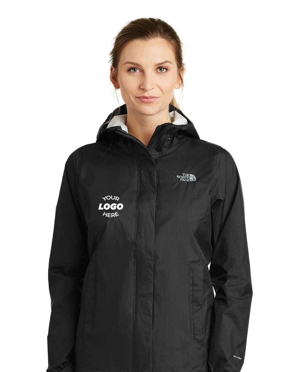 A person is wearing a black The North Face Ladies DryVent Rain Jacket NF0A3LH5 with "YOUR LOGO HERE" printed on the left side. This stylish piece features DryVent technology, ensuring it is breathable and waterproof for all-weather comfort.