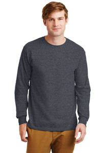 A man stands against a white background wearing tan pants and a dark gray Gildan 2400 long sleeve T-shirt, made from 100% US cotton, featuring a custom screen printed logo. (Pack of 36).
