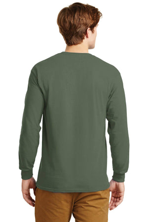 A man is shown from the back, wearing a Gildan 100% US Cotton Long Sleeve T-Shirt 2400 in olive green with custom screen printed logo, and brown pants, standing against a plain background. (Pack of 36).