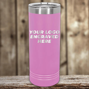 Pink insulated tumbler with Custom Logo 22 oz Skinny Tumbler - Front side Logo Included text on a wooden surface, with Kodiak Coolers blurred background.