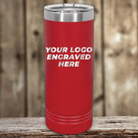 Red Kodiak Coolers custom logo 22 oz skinny tumbler, with "your custom logo engraved here" text, displayed on a wooden surface against a blurred background.