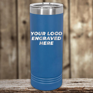 A blue insulated custom logo 22 oz skinny tumbler with "your custom logo engraved here" text, displayed on a wooden surface against a blurred background by Kodiak Coolers.