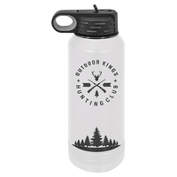 White water bottle from Kodiak Coolers featuring the "Outdoor Kings Hunting Club" logo with crossed arrows, a deer head, and trees. This NEW ION Plated Tumbler is custom engraved in "Ghost Black & Rose Gold" for an elegant promotional gift. The base displays a silhouette of pine trees, making it perfect for adventurers who value both design and functionality in their gear.