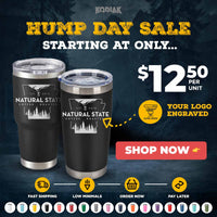Two black tumblers from Kodiak Coolers' Black Friday Sale are $12.50 each, featuring custom logo engraving (1 side, no setup fee) and "Natural State Coffee Roastery" branding. "Shop Now" and service icons appear at the bottom.