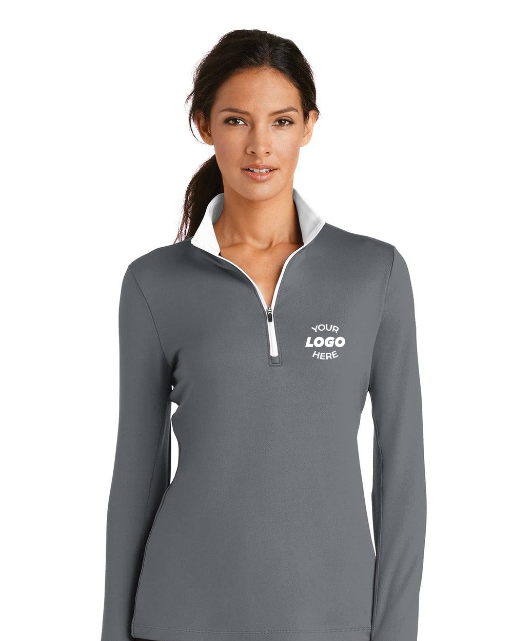 A woman wears a gray Nike Ladies Dri-FIT Stretch 1/2-Zip Pullover (779796) with a white zipper and "Your Logo Here" on the left chest.